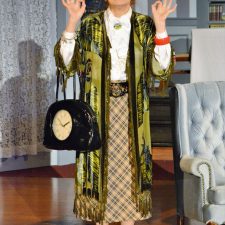 Madam Arcati with hands in the air holding purse