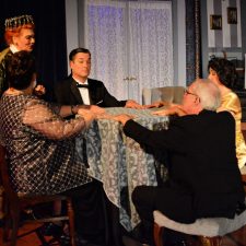 Cast of Blithe Spirit sitting around table