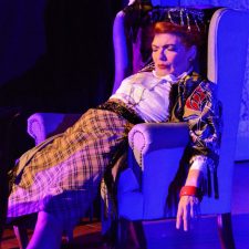 Madame Arcati laying across chair after falling