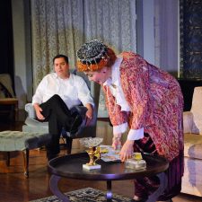 Madame Arcati reading tarot cards to Charles