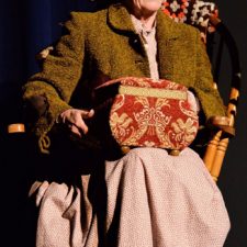 Ginny Racette sitting in a rocking chair acting in On Golden Pond