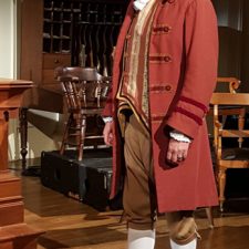 Joe-Michael Jackson in costume standing on stage while acting in 1776